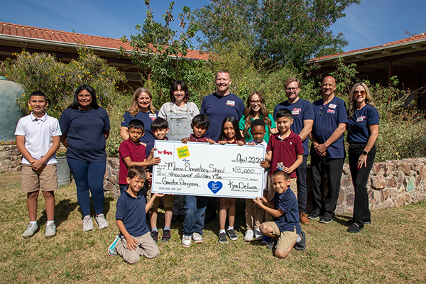 Students and staff smile with the $10,000 check from Fry's stores