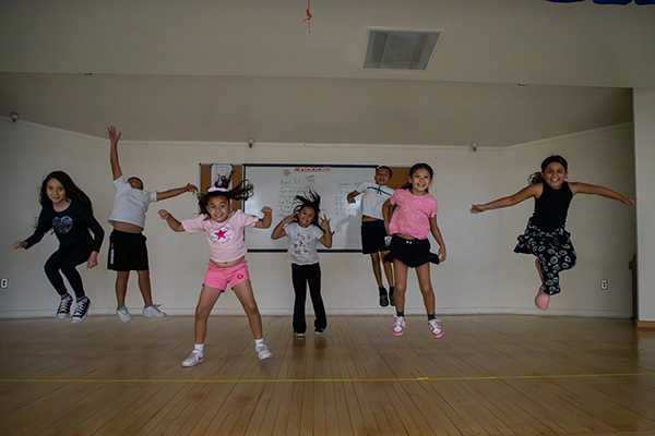 Students dance around on stage
