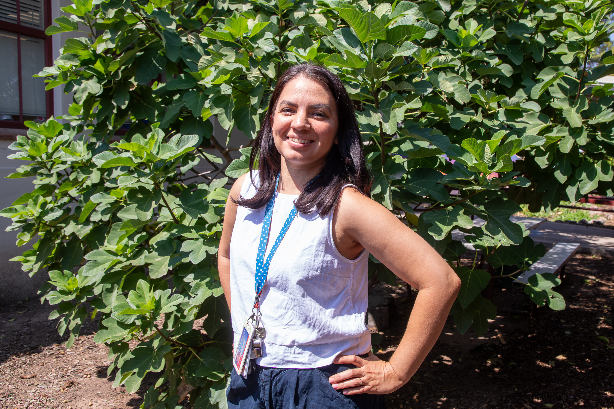 A woman smiles in the school garden
